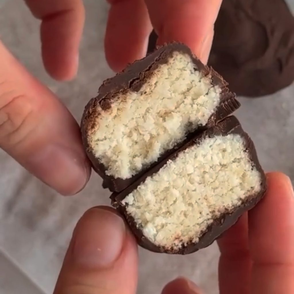 Chocolate-covered coconut bar, sliced open.