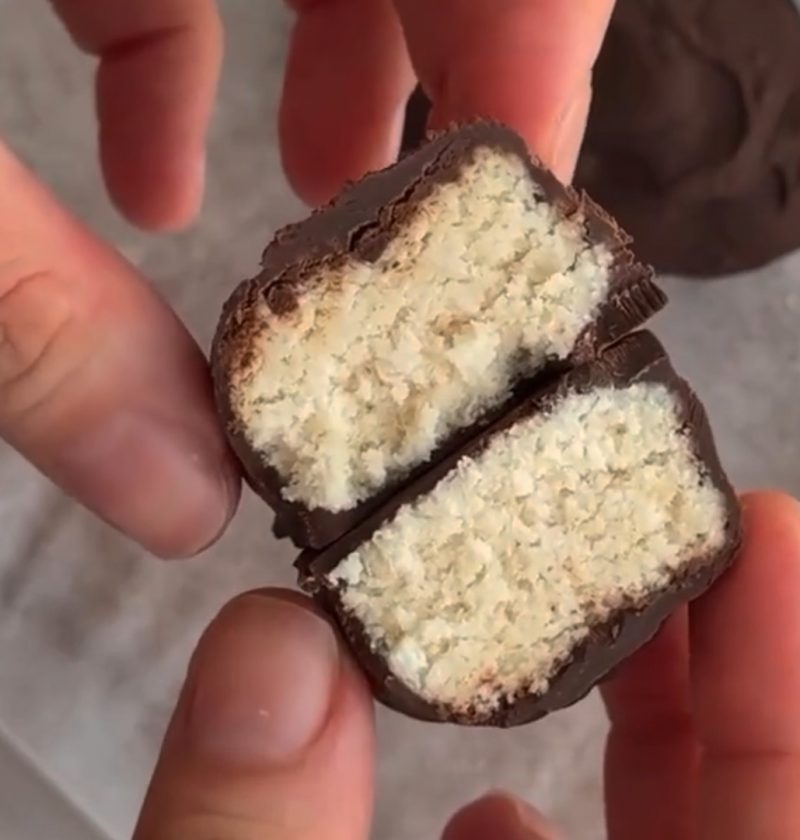Chocolate-covered coconut bar, sliced open.