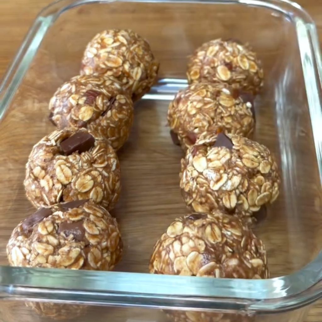eight Peanut Butter Oatmeal Balls in a glass container